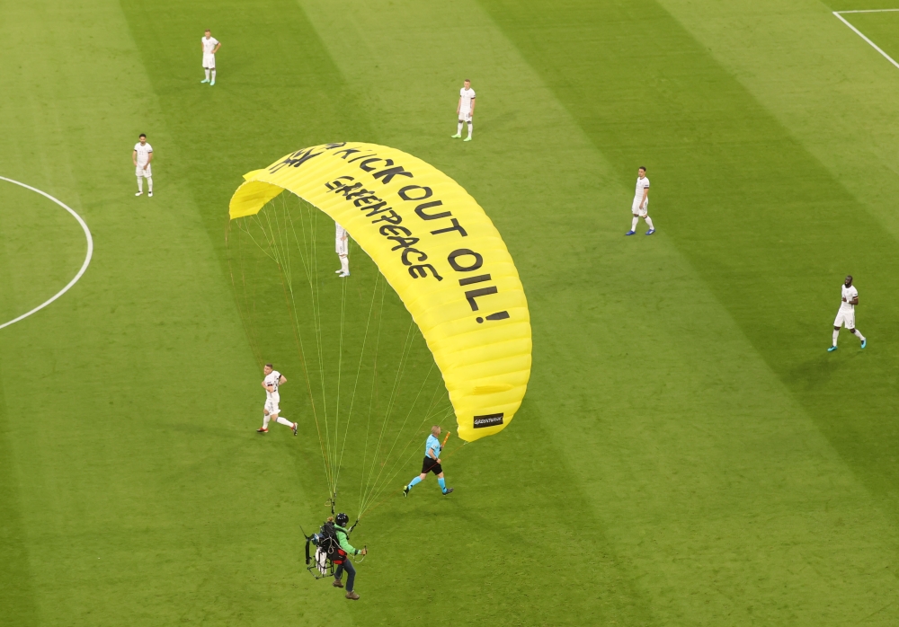  A Greenpeace protestor glides onto the pitch before the match Pool via Reuters/Alexander Hassenstein
