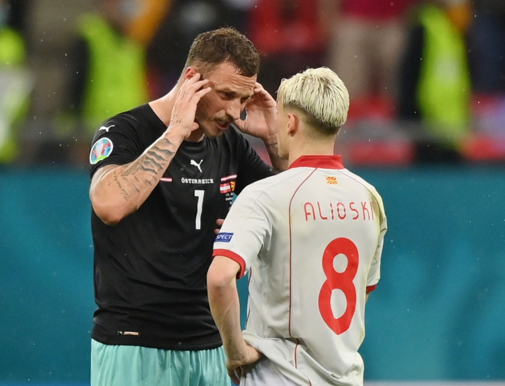Soccer Football - Euro 2020 - Group C - Austria v North Macedonia - National Arena, Bucharest, Romania - June 13, 2021 Austria's Marko Arnautovic and North Macedonia's Ezgjan Alioski after the match Pool via REUTERS/Justin Setterfield
