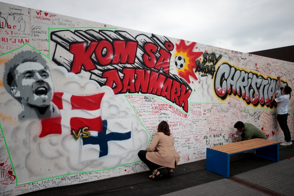 People write get well messages on a wall at a fanzone in Copenhagan after Denmark's Christian Eriksen collapsed on the pitch during his side's Euro 2020 match with Finland Reuters/Hannah Mckay