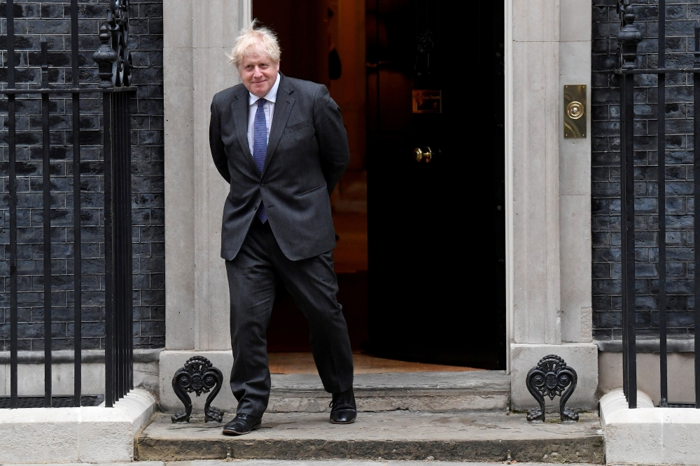 Britain's Prime Minister Boris Johnson stands in front of 10 at Downing Street, in London, Britain June 17, 2021. REUTERS/Toby Melville/File Photo