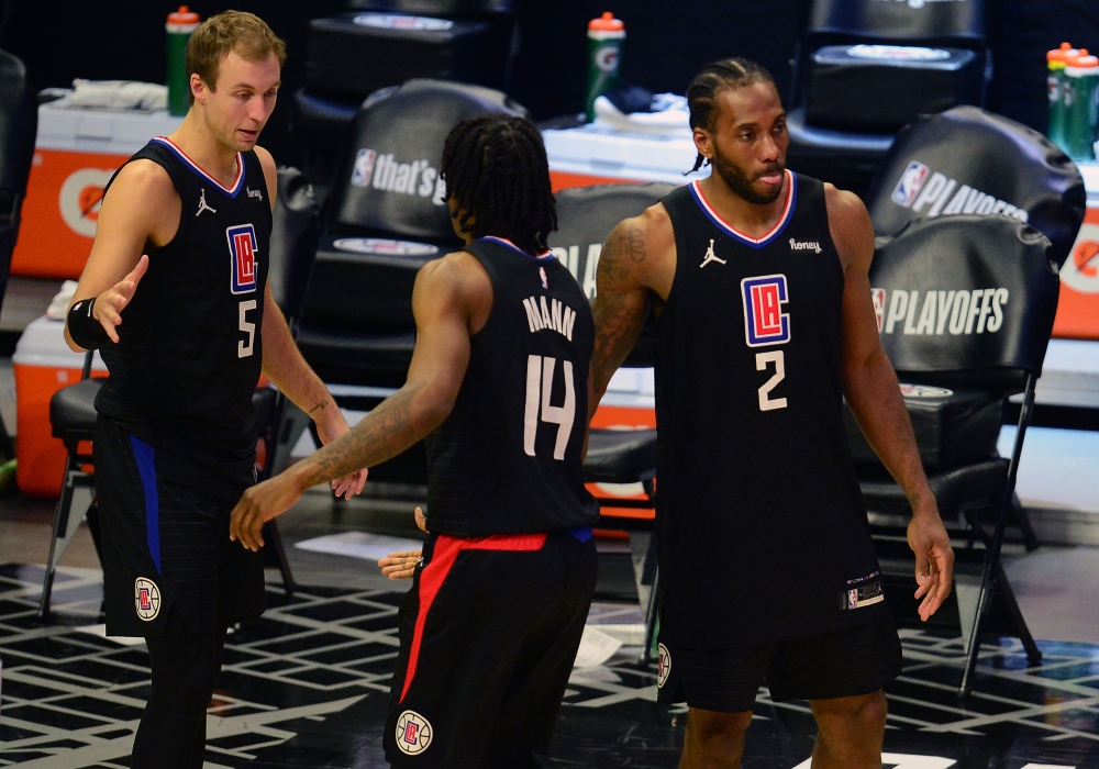 Los Angeles Clippers guard Luke Kennard (5) guard Terance Mann (14) and forward Kawhi Leonard (2) celebrate the 118-104 victory against the Utah Jazz in game four in the second round of the 2021 NBA Playoffs. at Staples Center. Mandatory Credit: Gary A. V