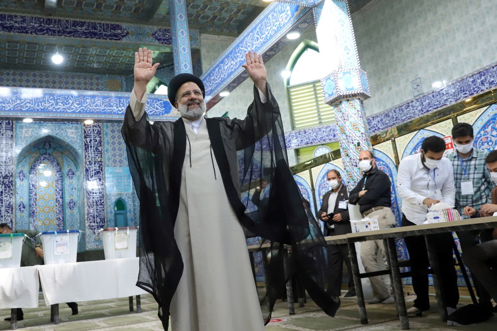 Presidential candidate Ebrahim Raisi gestures after he votes during presidential elections at a polling station in Tehran, Iran June 18, 2021. 