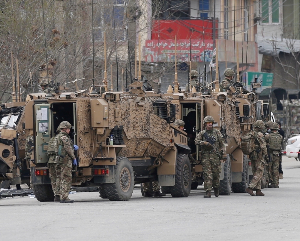 NATO soldiers inspect near the site of an attack in Kabul, Afghanistan March 25, 2020. Reuters/Mohammad Ismail/File Photo