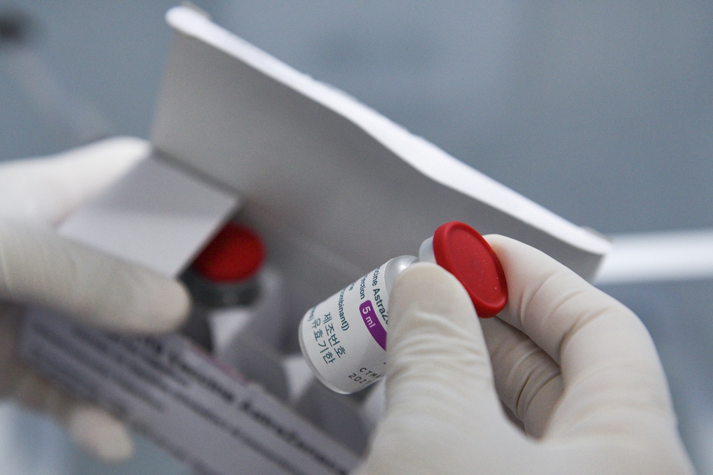 A health worker holds a vial of the vaccine as Vietnam starts its official rollout of AstraZeneca's coronavirus disease (COVID-19) vaccine for health workers, at Hai Duong Hospital for Tropical Diseases, Hai Duong province, Vietnam, March 8, 2021. REUTERS