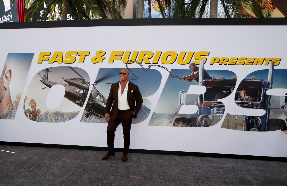  Cast member and producer Dwayne Johnson poses at the premiere for 