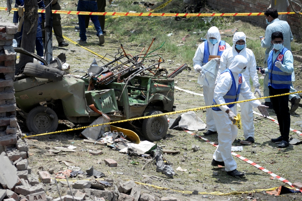 Members of the Counter Terrorism Department (CTD) survey the site after a deadly blast in residential area in Lahore, Pakistan June 23, 2021. REUERS/Mohsin Raza