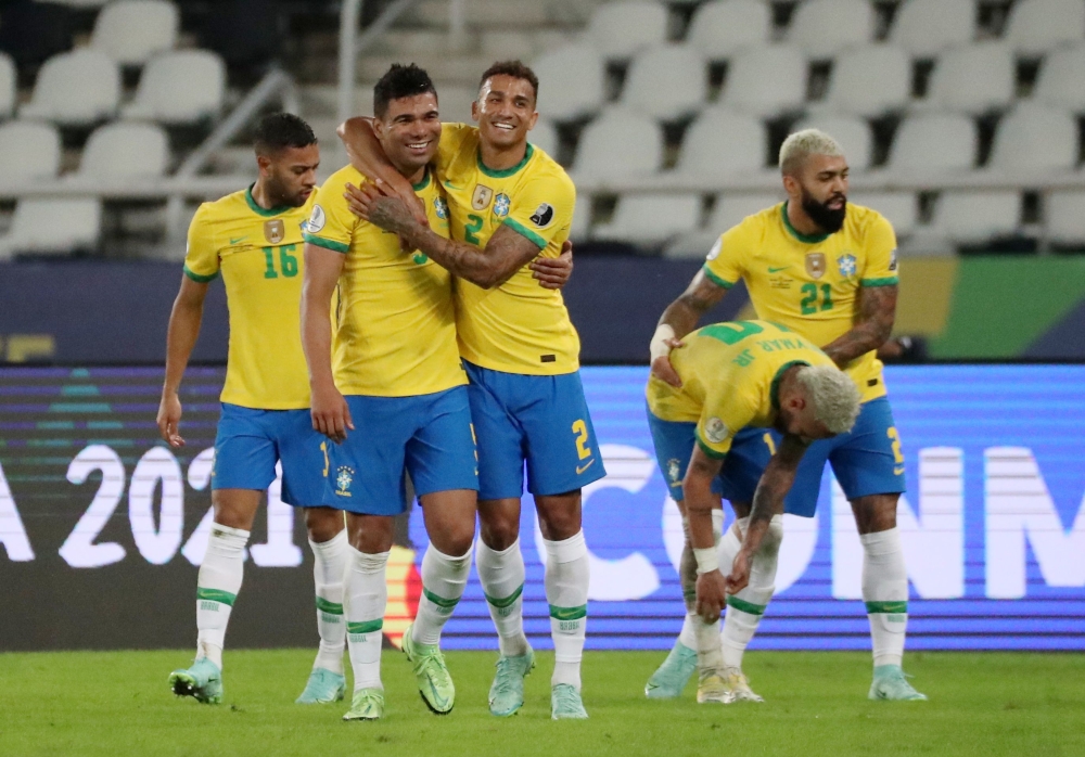 Brazil's Casemiro celebrates scoring their second goal with Danilo REUTERS/Sergio Moraes