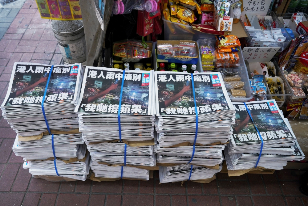 Copies of the final edition of Apple Daily, published by Next Digital, are seen at a newsstand in Hong Kong, China June 24, 2021. REUTERS/Lam Yik