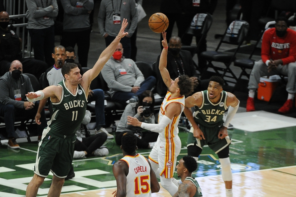 Atlanta Hawks guard Trae Young (11) puts up a shot against Milwaukee Bucks center Brook Lopez (11) in the second quarter during game one of the Eastern Conference Finals for the 2021 NBA Playoffs at Fiserv Forum.   Michael McLoone 