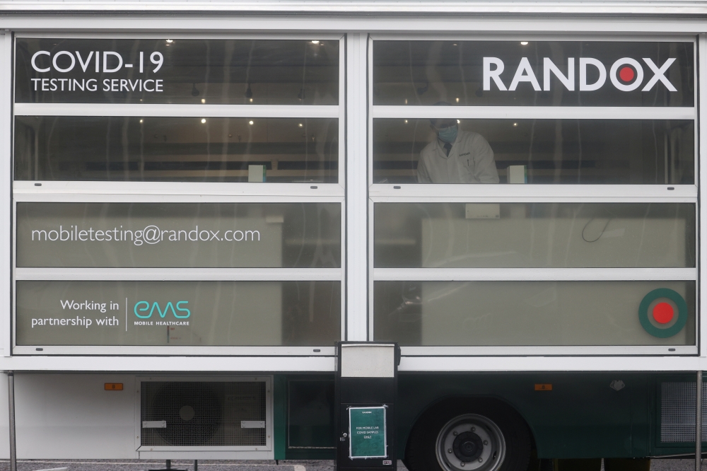 A healthcare worker stands inside the coronavirus disease (COVID-19) mobile testing site at Heathrow Airport, in London, Britain, February 15, 2021. REUTERS/Hannah McKay/File Photo
