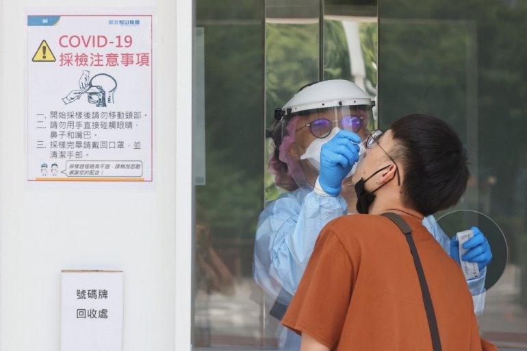 A medical worker conducts a rapid test for coronavirus disease (COVID-19) on a Taiwanese resident following an increasing number of locally transmitted cases at Songshan Airport in Taipei, Taiwan, June 2, 2021. Reuters/Ann Wang