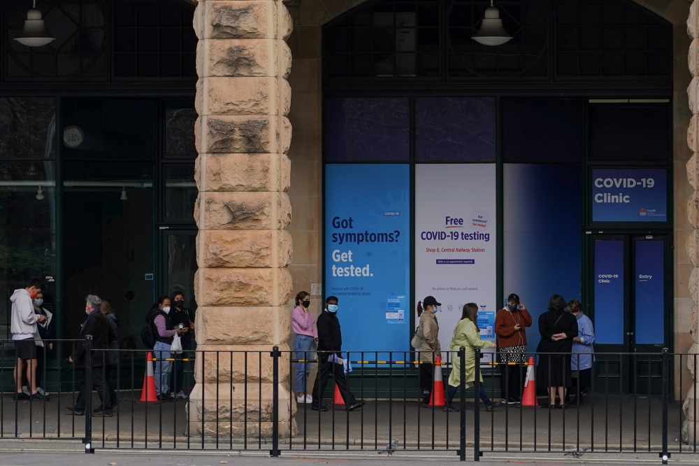 People wait in line outside a coronavirus disease (COVID-19) testing clinic as the city grapples with an outbreak of new cases in Sydney, Australia, June 23, 2021. REUTERS/Loren Elliott