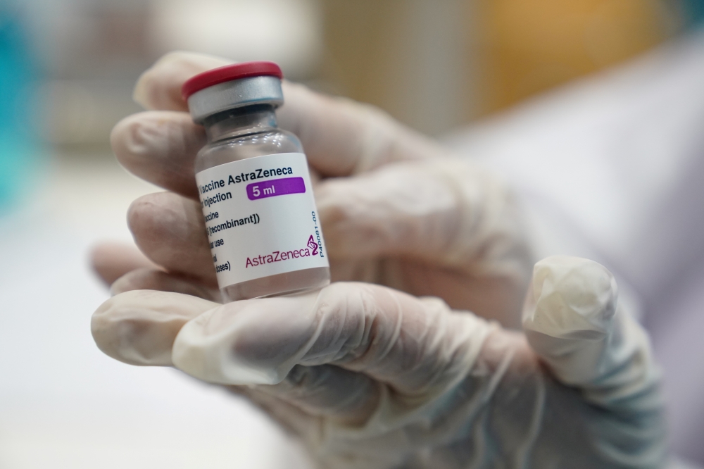 A health worker shows a vial of the AstraZeneca COVID-19 vaccine against the coronavirus disease (COVID-19) as Thailand start a mass inoculation at a gymnasium inside the Thammasat University in Pathum Thani, Thailand June 7, 2021. REUTERS/Athit Perawongm