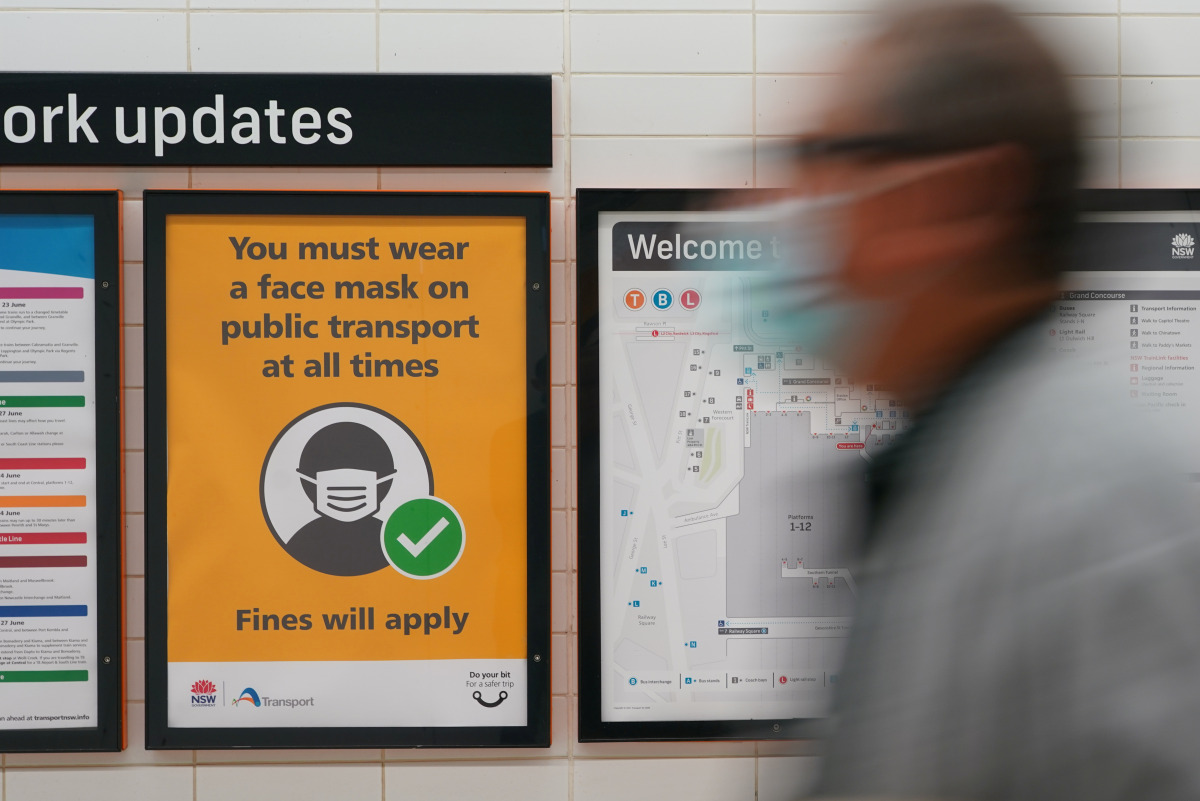 A sign at Central Station notes the implementation of new public health regulations from the state of New South Wales, as the city grapples with an outbreak of the coronavirus disease (COVID-19) in Sydney, Australia, June 23, 2021. REUTERS/Loren Elliott

