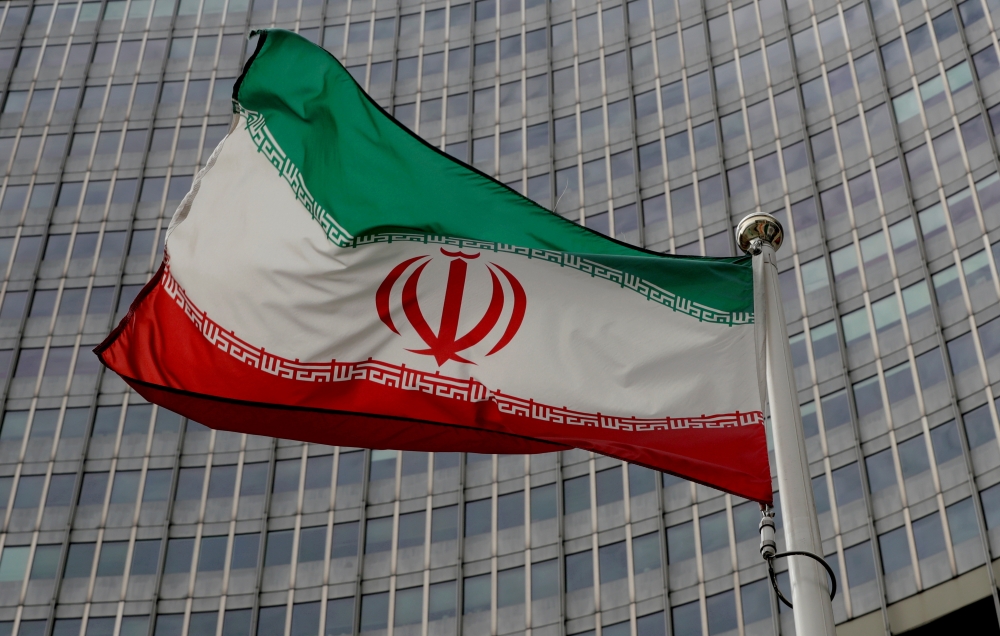 FILE PHOTO: An Iranian flag flutters in front of the International Atomic Energy Agency (IAEA) headquarters in Vienna, Austria, September 9, 2019. REUTERS/Leonhard Foeger