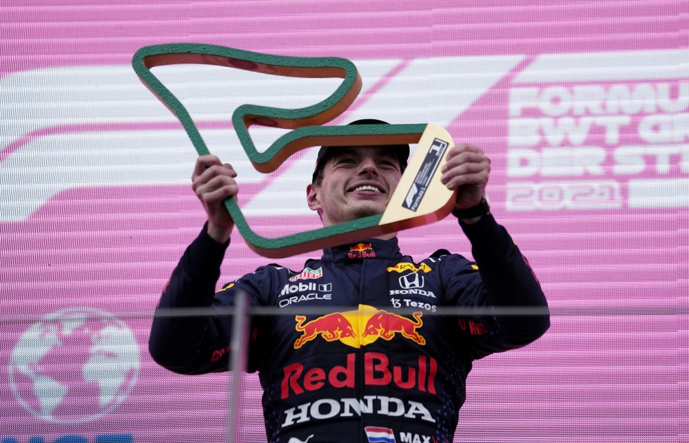 Red Bull's Max Verstappen celebrates with the trophy after winning the race Pool via REUTERS/Darko Vojinovic