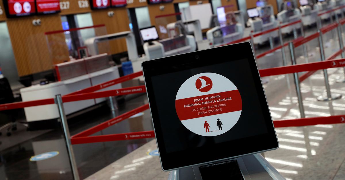 A social distancing sign is seen before the Turkish Airlines check-in counters at the international departure terminal of the Istanbul Airport amid the coronavirus disease (COVID-19) outbreak, in Istanbul, Turkey June 19, 2020. REUTERS/Murad Sezer
