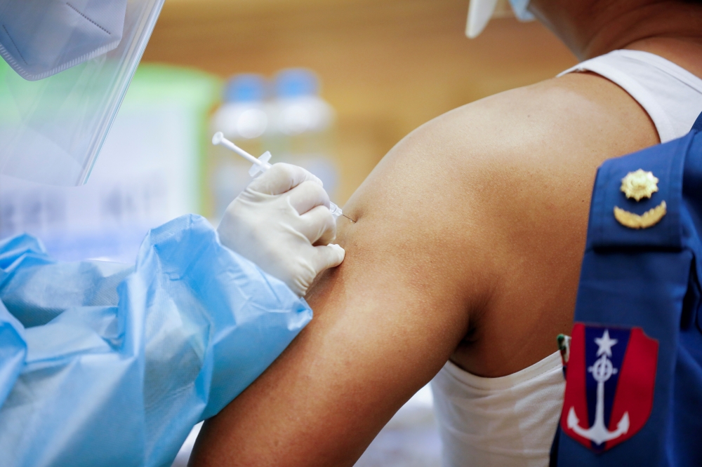 A member of the armed forces in parliament receives the AstraZeneca Covishield coronavirus vaccine in Naypyitaw, Myanmar, January 30, 2021. REUTERS/Thar Byaw/File Photo/File Photo