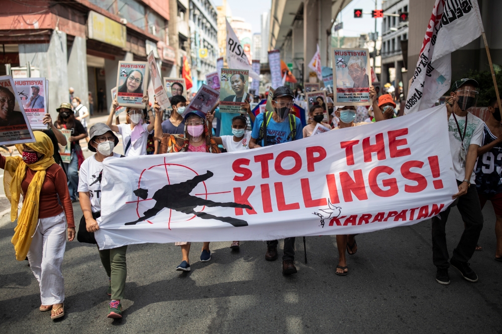 Protesters calling to stop extra-judicial killings march towards the presidential Malacanang Palace during a protest to commemorate President Rodrigo Duterte's final year in office, in Manila, Philippines, June 30, 2021. REUTERS/Eloisa Lopez