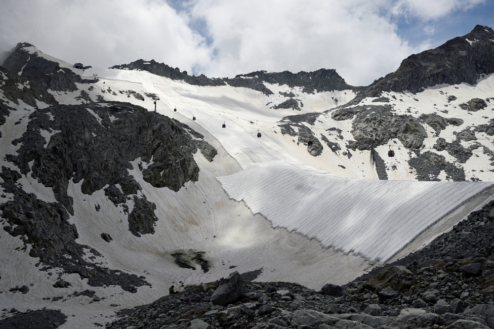 Large white geotextile sheets cover northern Italy's Presena glacier in order to delay snow melting on skiing slopes and reflect sunlight during summer months, at Passo del Tonale, near Trento, Italy, July 13, 2020. REUTERS/Flavio Lo Scalzo/File Photo/Fil