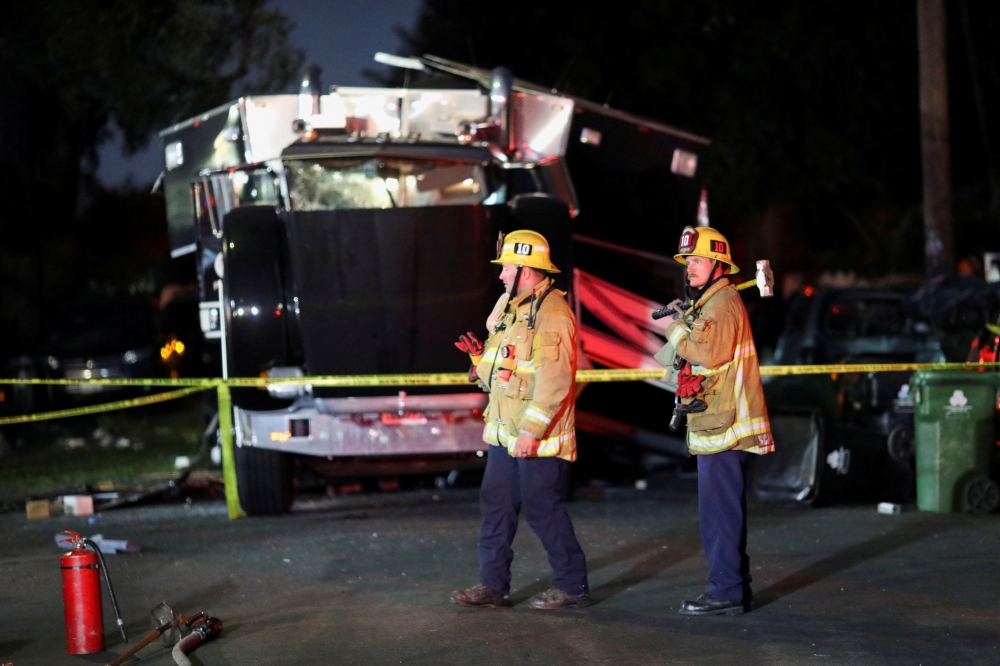 A damaged vehicle is seen at the site of an explosion after police attempted to safely detonate illegal fireworks that were seized, in Los Angeles, California, U.S., June 30, 2021. REUTERS/David Swanson