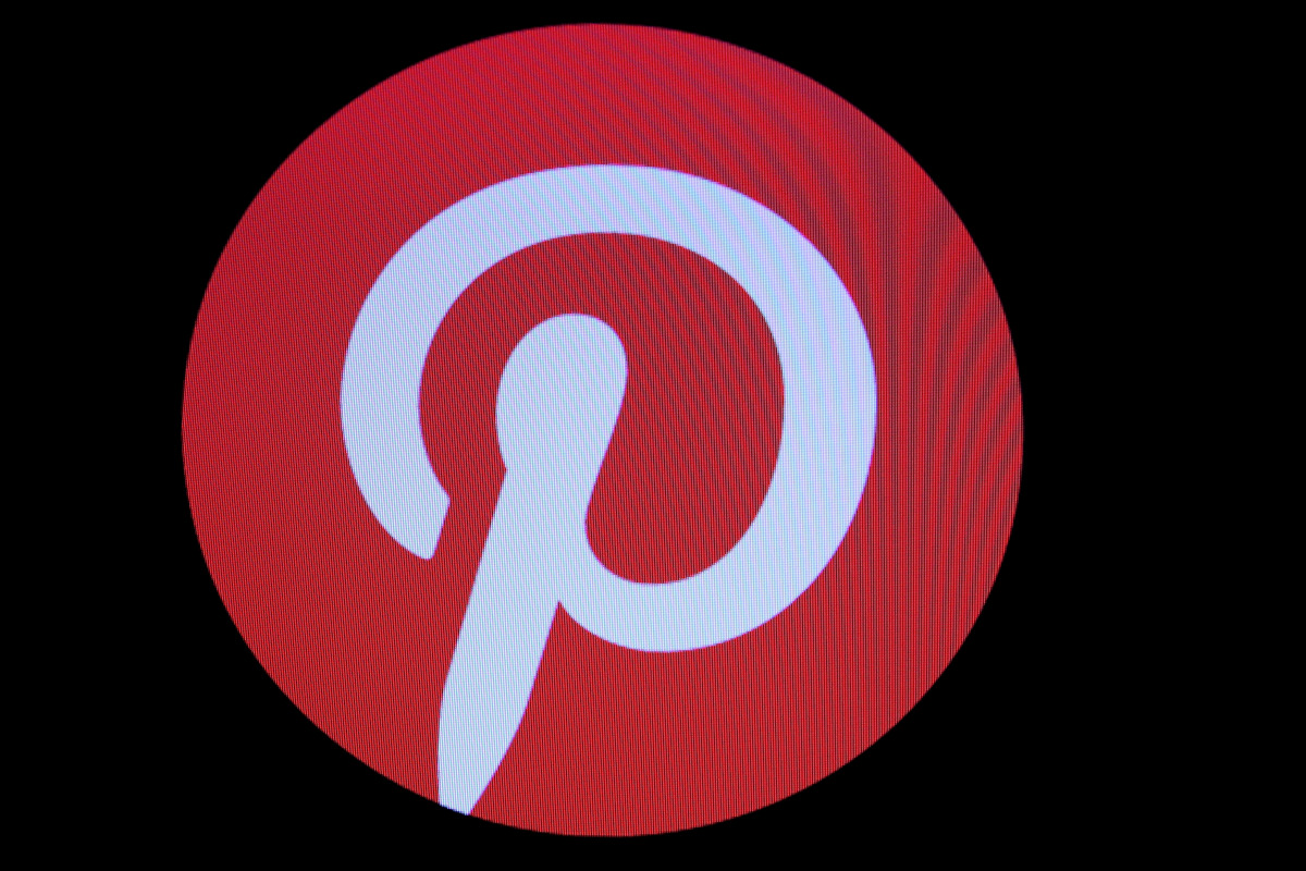 FILE PHOTO: Screens display the company logo for Pinterest Inc. during the company's IPO on the front of the New York Stock Exchange (NYSE) in New York, U.S., April 18, 2019. REUTERS/Brendan McDermid/File Photo
