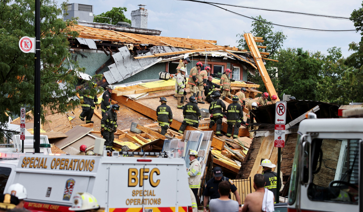 Emergency personnel clear debris as they search for trapped construction workers after a building undergoing construction collapsed in Washington, U.S., July 1, 2021. REUTERS/Evelyn Hockstein
