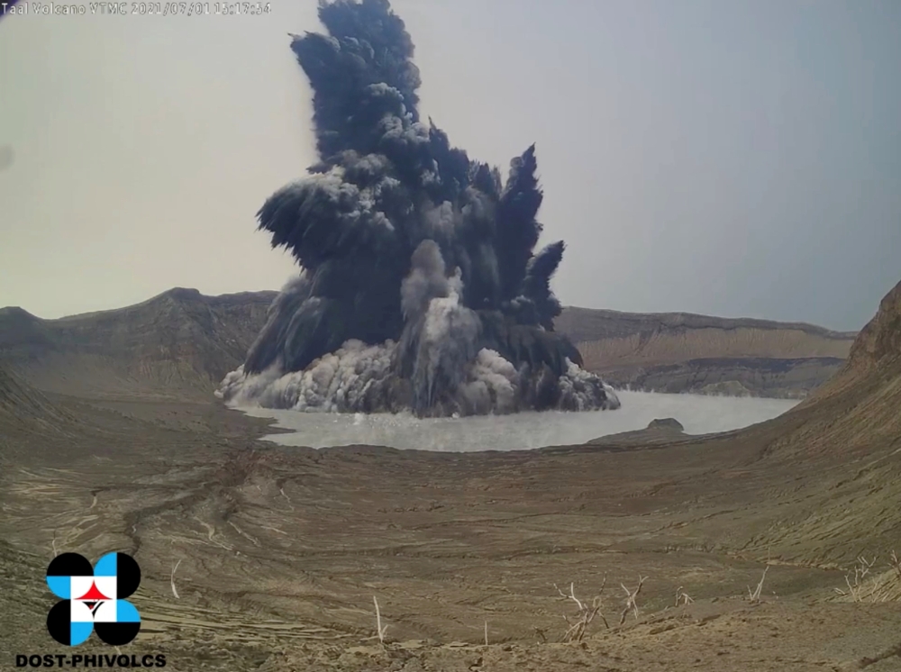A phreatomagmatic eruption plume billows from Taal volcano, Batangas province, Philippines July 1, 2021. in this screen grab obtained from a social media video. Video recorded July 1, 2021. PHIVOLCS-DOST via REUTERS