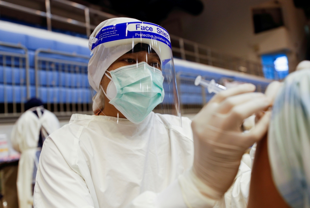 A person receives the Sinovac coronavirus disease (COVID-19) vaccine as the Thai resort island of Phuket rushes to vaccinate its population amid the COVID-19 outbreak ahead of a July 1 end of strict quarantine for overseas visitors to bring back tourism r
