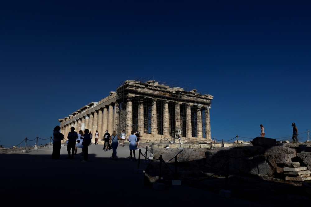FILE PHOTO: People visit the Parthenon temple atop the Acropolis hill in Athens, Greece, June 8, 2021. Picture taken June 8, 2021. REUTERS/Alkis Konstantinidis/File Photo
