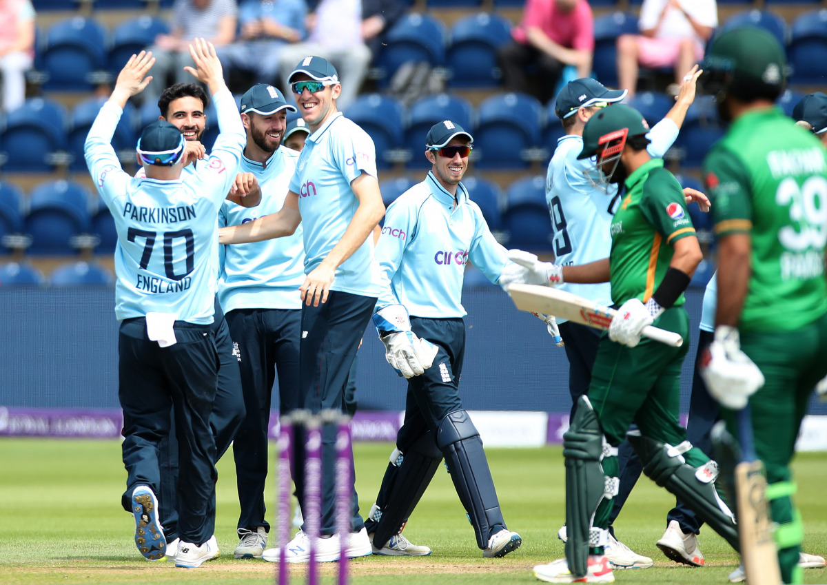 Cricket - First One Day International - England v Pakistan - Sophia Gardens, Cardiff, Wales, Britain - July 8, 2021 England's Saqib Mahmood celebrates taking the wicket of Pakistan's Babar Azam, caught by Zak Crawley with teammates Action Images via Reute