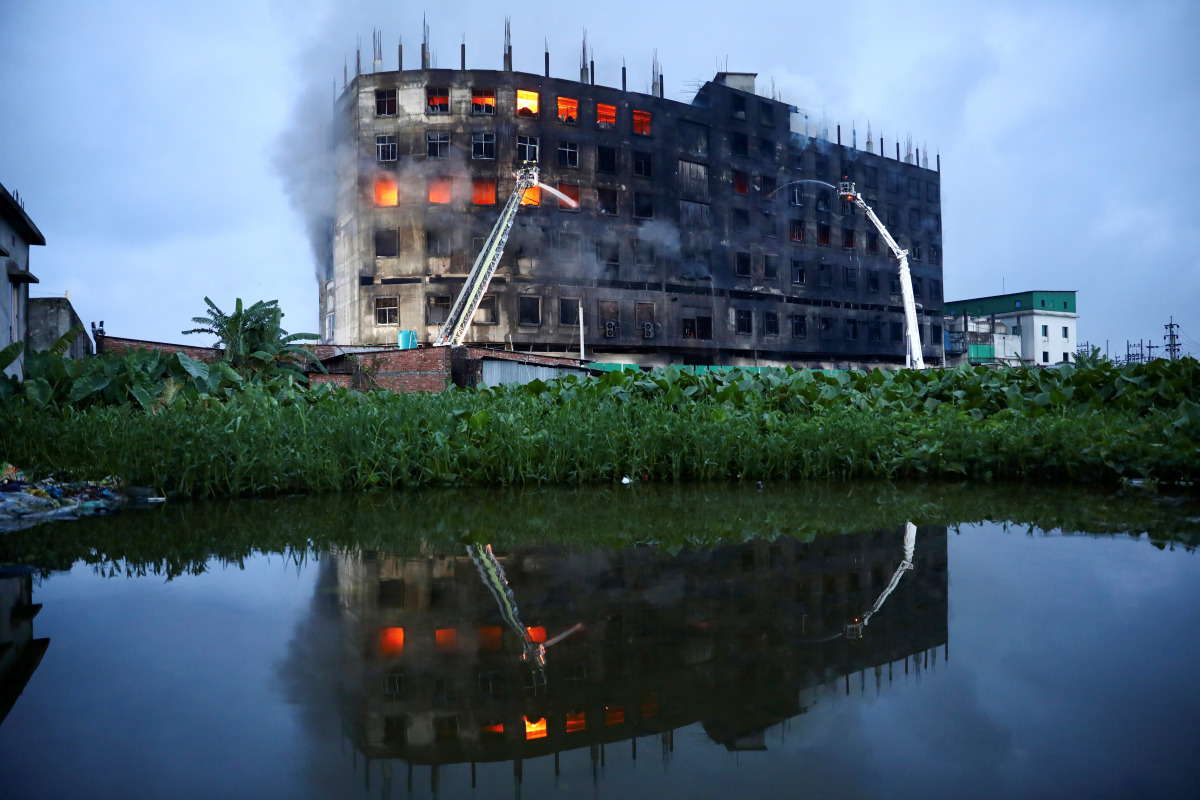Flames rise the morning after a fire broke out at a factory named Hashem Foods Ltd. in Rupganj of Narayanganj district, on the outskirts of Dhaka, Bangladesh, July 9, 2021. REUTERS/Mohammad Ponir Hossain
