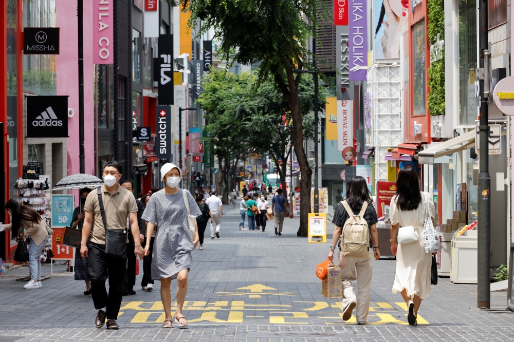 People wearing masks walk in a shopping district amid the coronavirus disease (COVID-19) pandemic in Seoul, South Korea, July 9, 2021. REUTERS/ Heo Ran