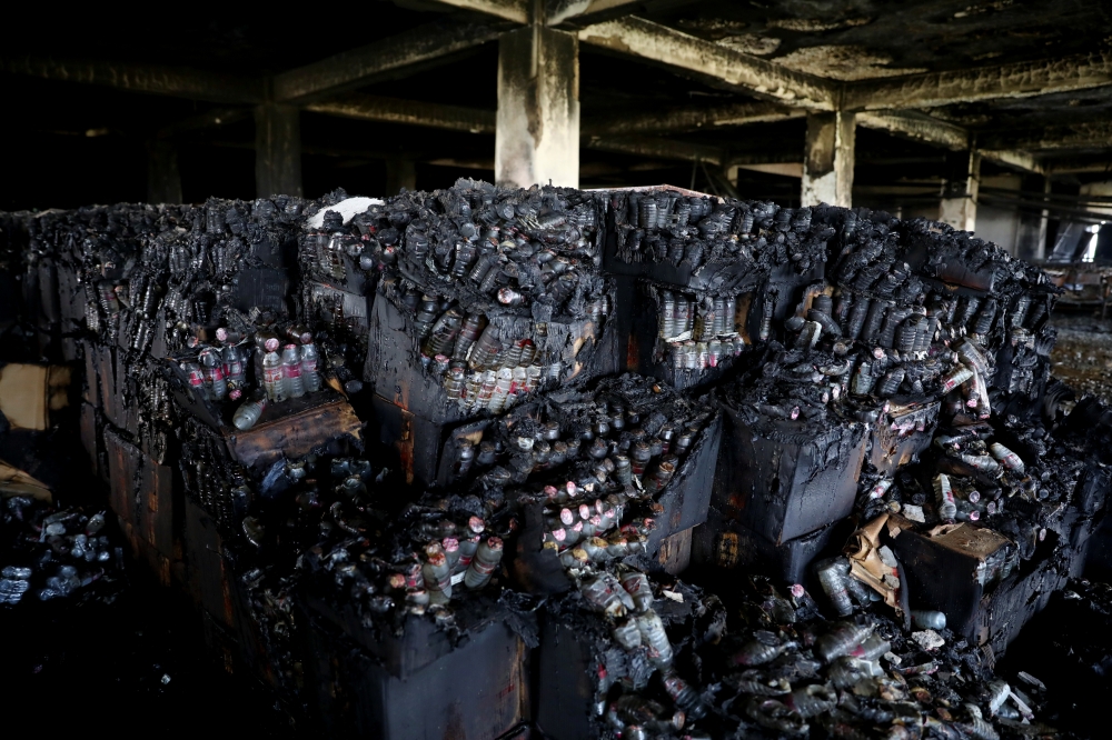 Burnt bottles are seen after a fire broke out at Hashem Foods Ltd factory, in Rupganj, Narayanganj district, on the outskirts of Dhaka, Bangladesh, July 10, 2021. (REUTERS/Mohammad Ponir Hossain)