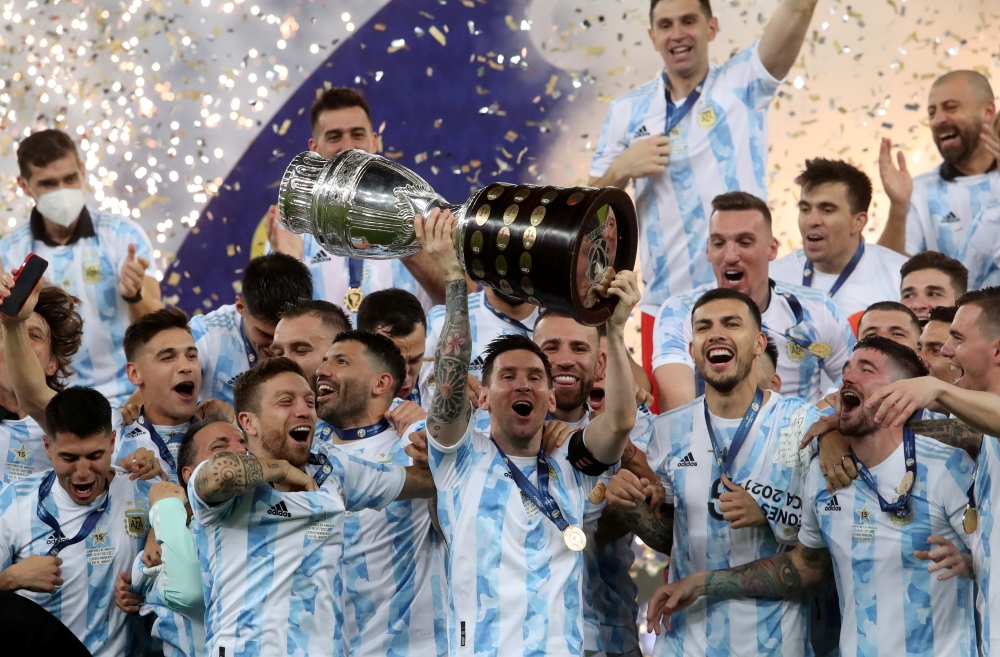  July 10, 2021 Argentina's Lionel Messi and teammates celebrate winning the Copa America with the trophy REUTERS/Amanda Perobelli