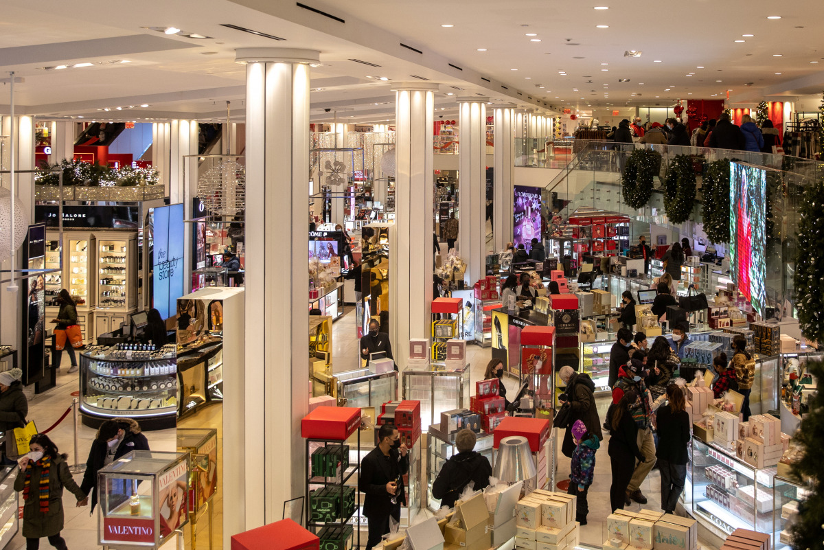 FILE PHOTO: People wearing protective masks shop at Macy's Herald Square following the outbreak of COVID-19 in New York City, December 26, 2020 JEENAH MOON/REUTERS