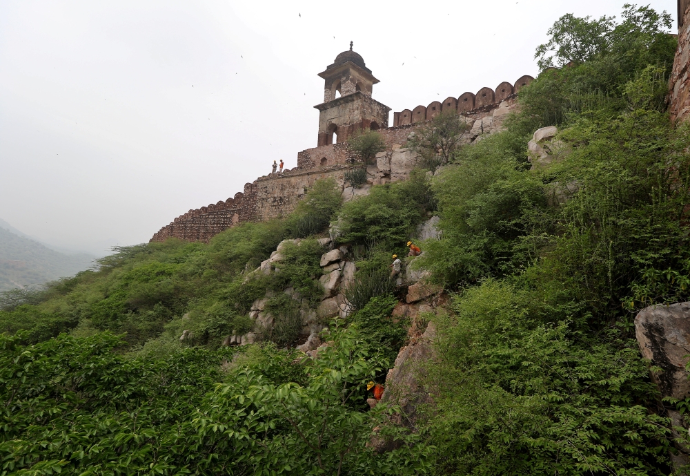 Members of the State Disaster Response Force (SDRF) conduct a search operation following a lightning strike at a watch tower near Amer Fort in Jaipur in the desert state of Rajasthan, India, July 12, 2021. REUTERS/Stringer 