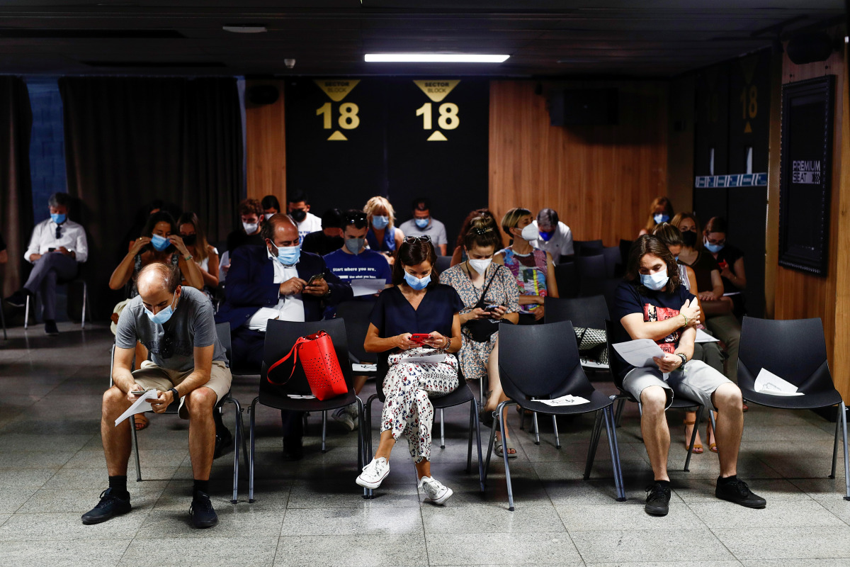 People sit after they received a coronavirus disease (COVID-19) vaccine as the country extends vaccination to curb surge among population under 30, in Madrid, Spain, July 12, 2021. REUTERS/Javier Barbancho
