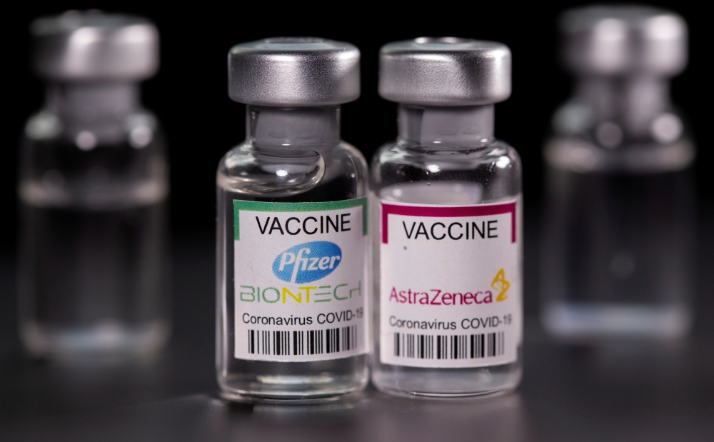 Vials with Pfizer-BioNTech and AstraZeneca coronavirus disease (COVID-19) vaccine labels are seen in this illustration picture taken March 19, 2021. REUTERS/Dado Ruvic/Illustration/File Photo