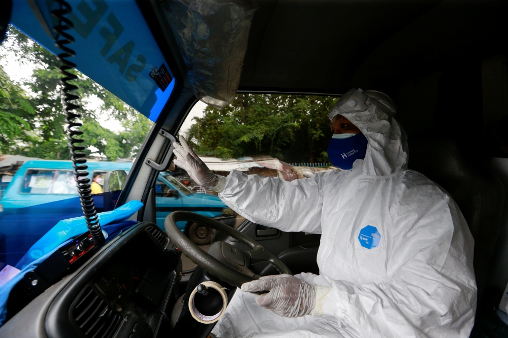 Sunaryo drives an ambulance as he delivers a patient suffering from coronavirus disease (COVID-19), as cases surge in Depok, on the outskirts of Jakarta, Indonesia, July 13, 2021. REUTERS/Ajeng Dinar Ulfiana