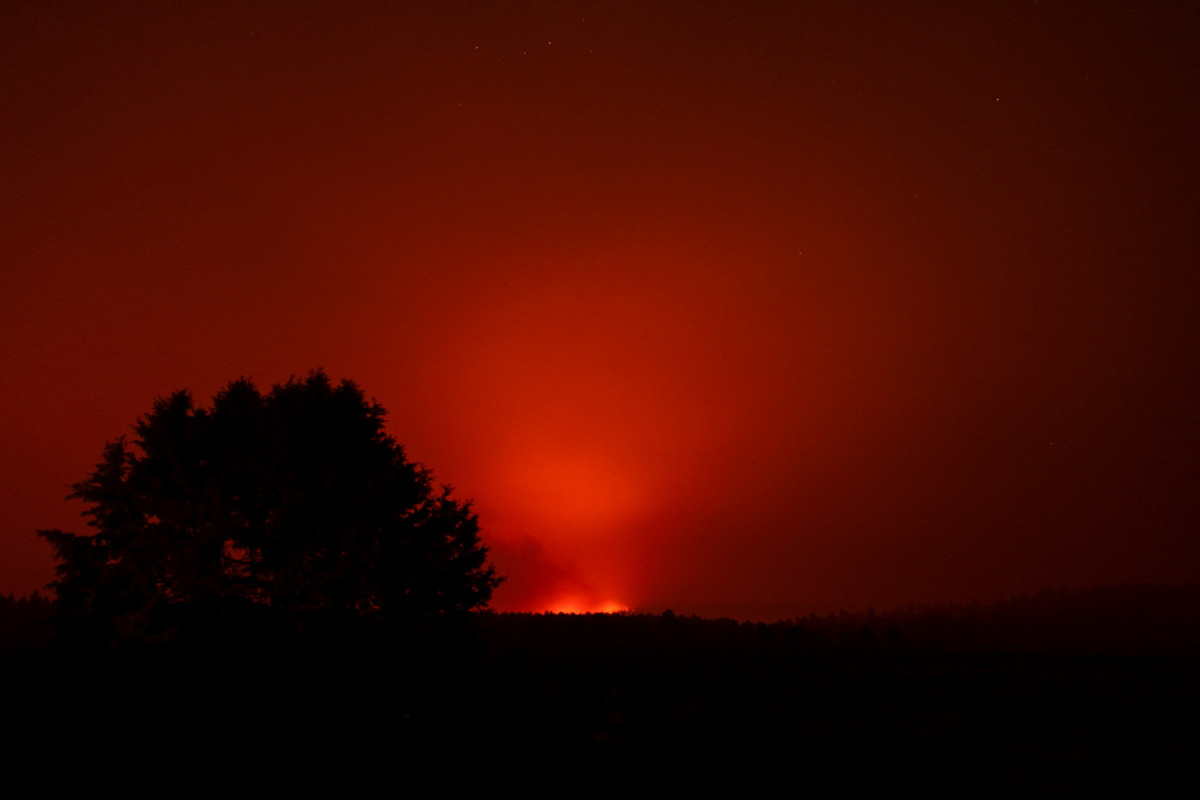 The Bootleg Fire glows in the distance, near Beatty, Oregon, U.S., July 13, 2021. Picture taken July 13, 2021. REUTERS/Mathieu Lewis-Rolland
