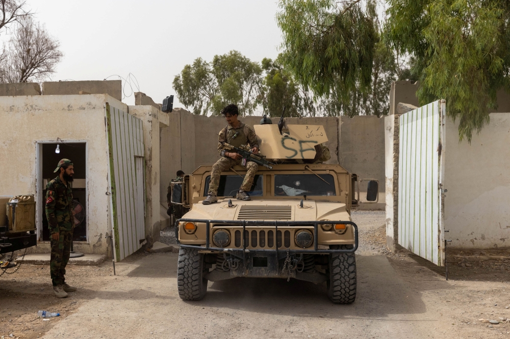 A member of Afghan Special Forces sits on the rooftop of his humvee as he arrives at the base after heavy clashes with Taliban during the rescue mission of a policeman besieged at a check post, in Kandahar province, Afghanistan, July 13, 2021. (REUTERS/Da