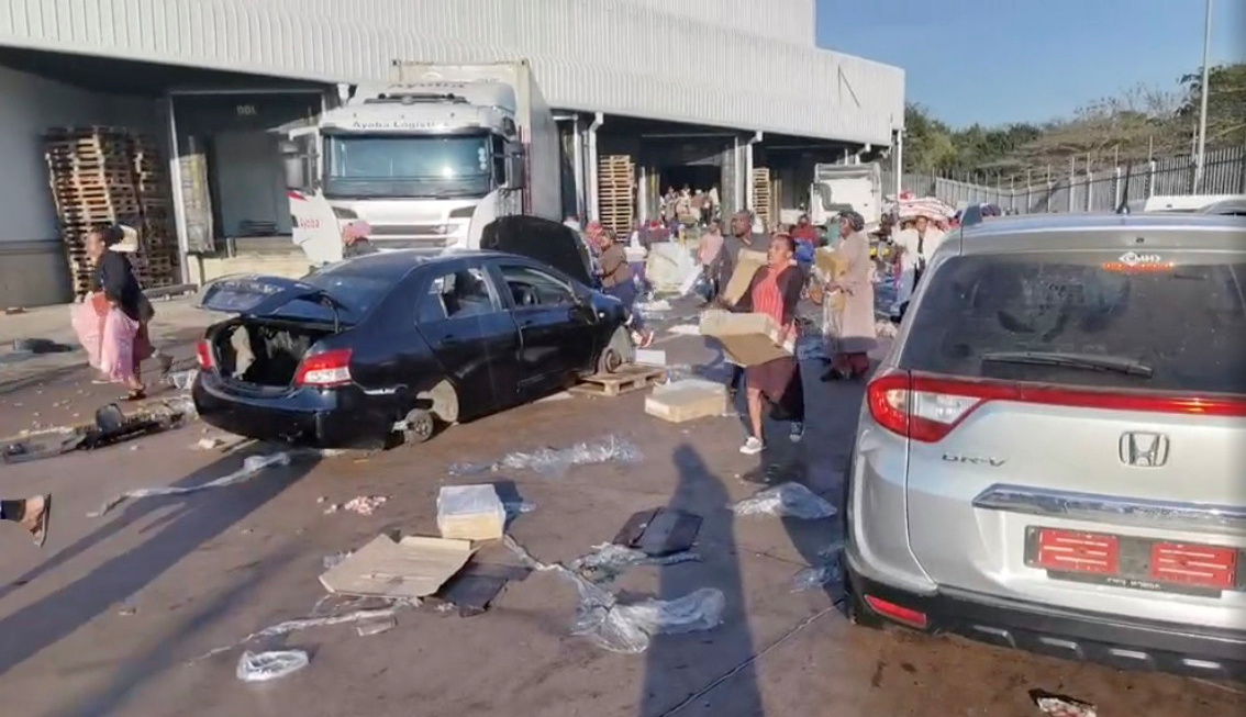 Demonstrators loot the Ayoba Cold Store as protests continue, following imprisonment of former South Africa President Jacob Zuma, in Chesterville, Durban, KwaZulu-Natal, South Africa July 12, 2021, in this still image obtained from social media video. Sip