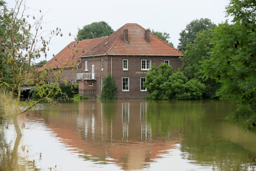 High water is seen near a house, in Roermond, Netherlands, July 16, 2021. REUTERS/Eva Plevier