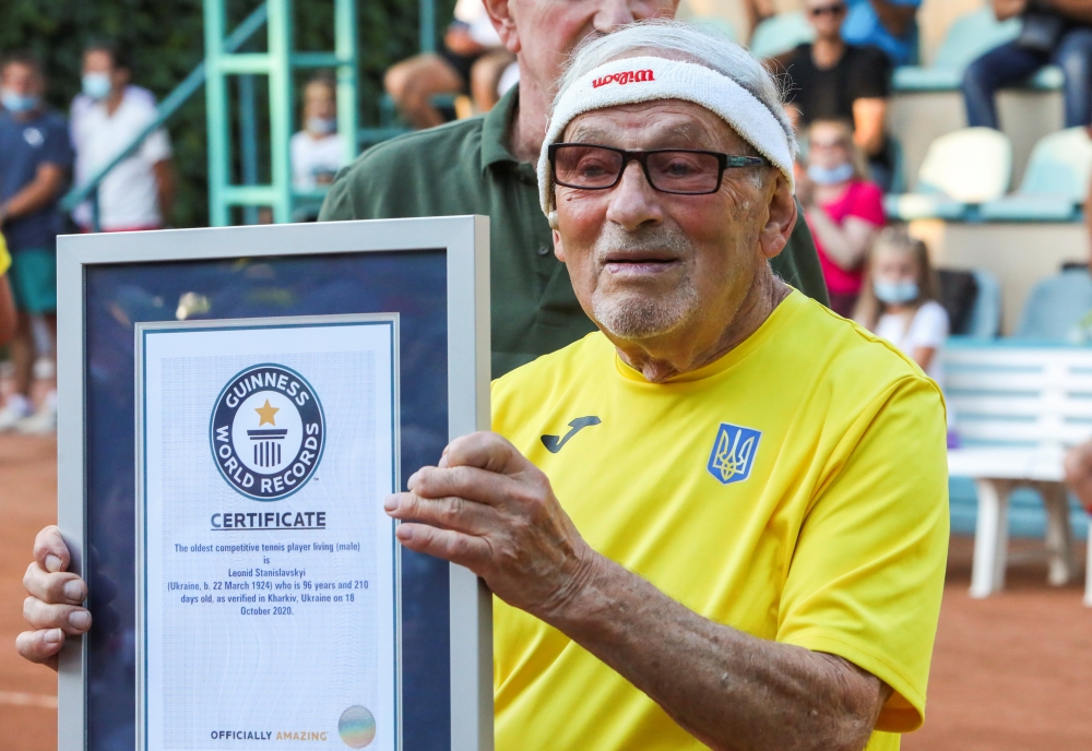 The world's oldest tennis player Ukrainian Leonid Stanislavskyi, 97, takes part in an award ceremony of the Guinness World Record certificate in Kharkiv, Ukraine July 7, 2021. Picture taken July 7, 2021. REUTERS/Vyacheslav Madiyevskyy