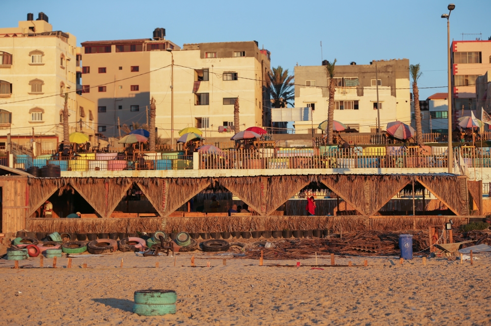 An environment-friendly beachfront cafe built of tonnes of solid waste is seen from the beach in Gaza July 8, 2021. (REUTERS/Ibraheem Abu Mustafa)