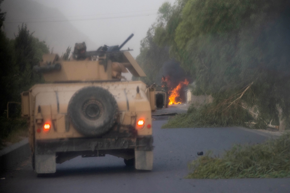 Humvees that belong to Afghan Special Forces are seen destroyed during heavy clashes with Taliban during the rescue mission of a police officer besieged at a check post, in Kandahar province, Afghanistan, July 13, 2021. (Reuters/Danish Siddiqui/File Photo