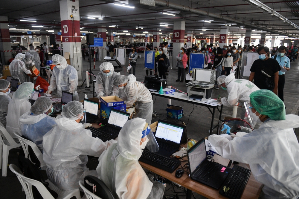 People queue for free coronavirus disease (COVID-19) rapid antigen tests at a mass testing station, as the spread of COVID-19 continues, in Bangkok, Thailand, July 15, 2021. REUTERS/Chalinee Thirasupa