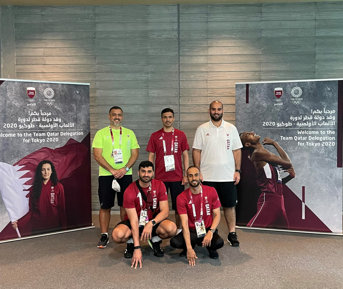 The Secretary-General of the Qatar Olympic Committee, Jassim bin Rashid Al Buenain, posing for a photograph with Qatari officials during a visit to the Athletes' Village in Tokyo, Japan, yesterday.