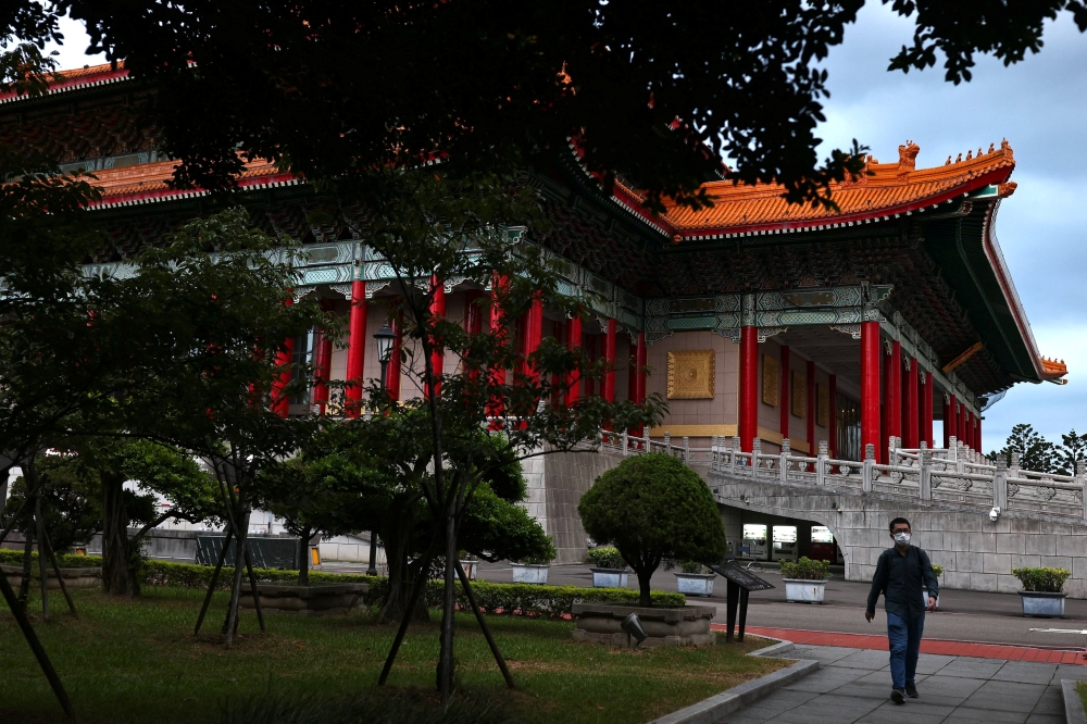 A man wearing a protective face mask walks towards a metro station after Central Epidemic Command Center (CECC) eased coronavirus disease (COVID-19) restrictions in Taipei, Taiwan, July 13, 2021. REUTER/Ann Wang